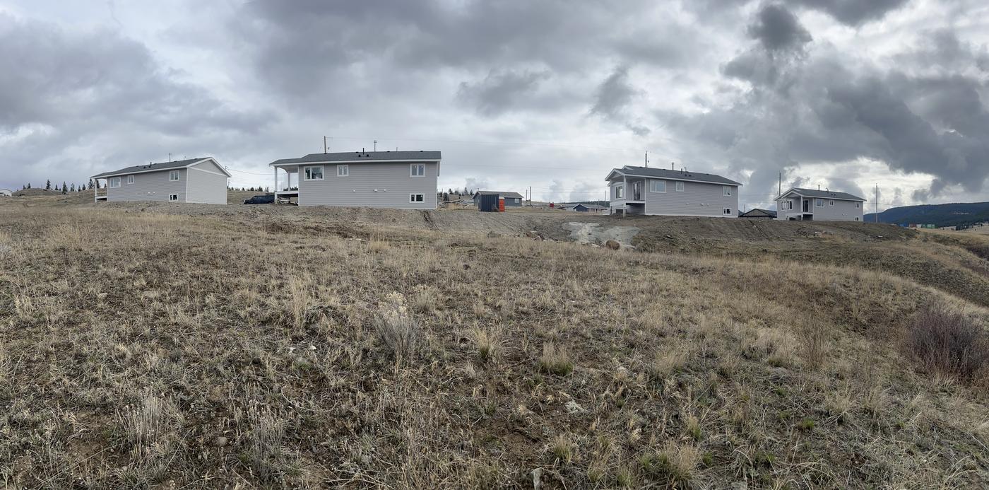 Four new grey-sided homes in a subdivision, clad by Brega